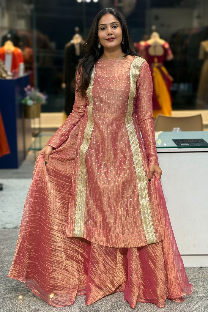 Dusty rose long dress with gold trim, flared hem, and metallic speckle detailing
